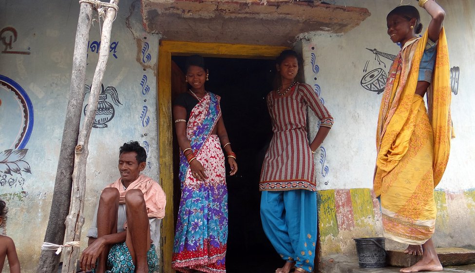 Top: Gundhar's wife Rashmita (standing, left), his sister-in-law, and parents-in-law outside their house in Tukla village