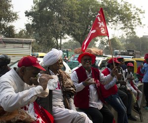 Satvir Singh, 61, third from the left, stops for a tea break on his way to Ramlila Maidan.