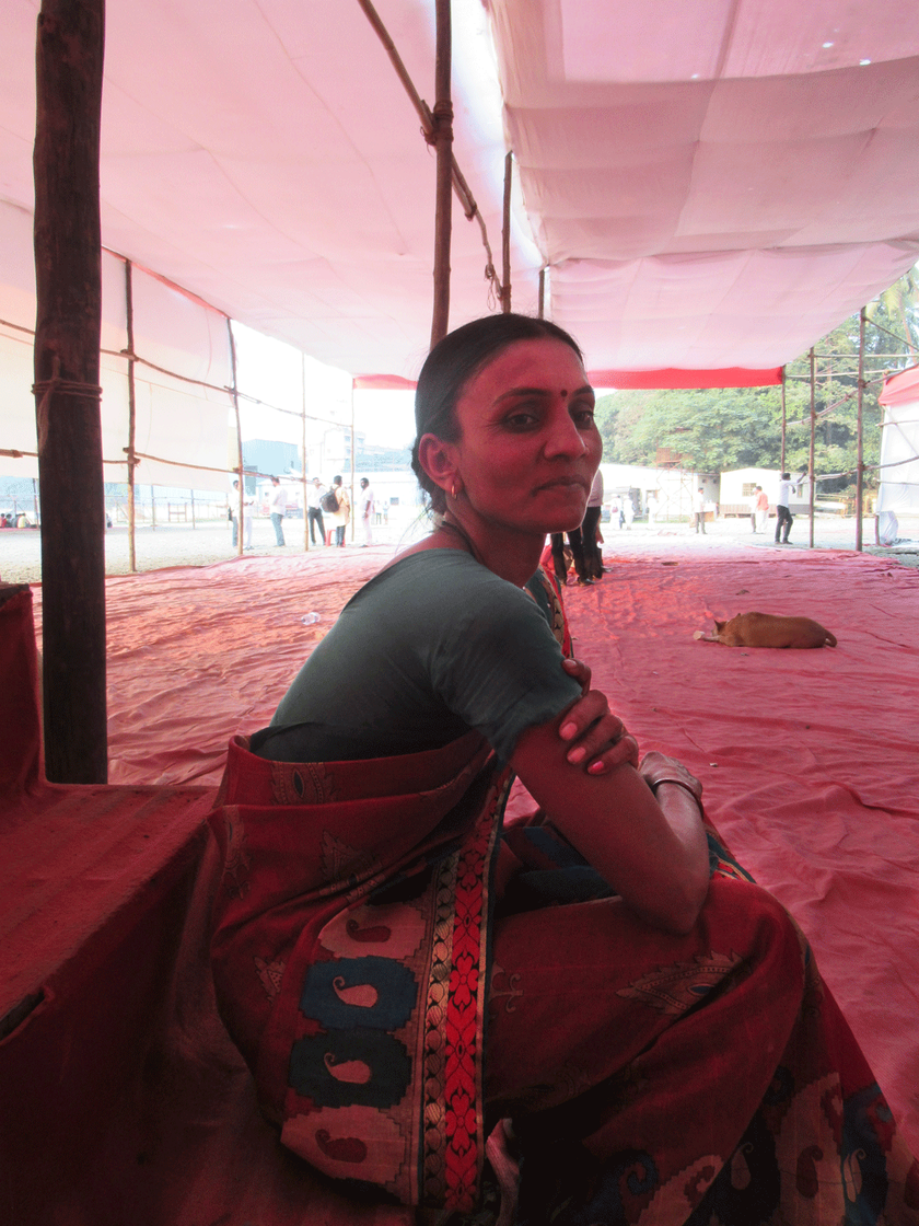 Lone woman sitting under empty pandal
