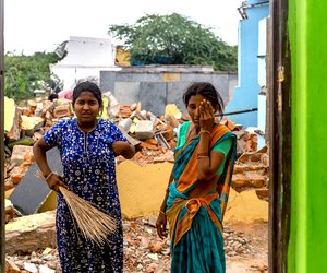 B. Venkatalakshmi and her daughter B. Kavita clean up after their home was bulldozed by the demolition crews