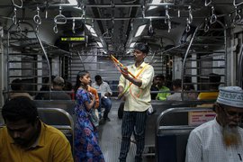 Hanging by strings on Mumbai locals