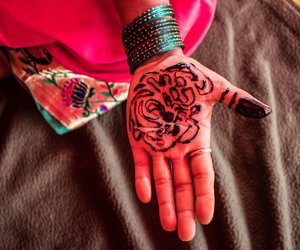 Decoration and demands: a farmer applying mehendi a day before the rally