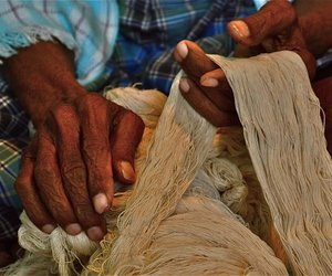 Man holding cotton thread