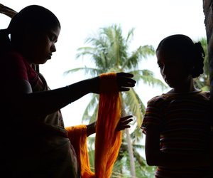 Two women with silk yarn